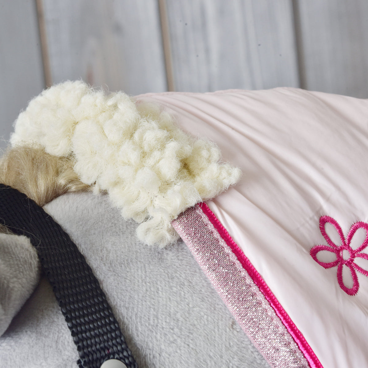 Close view of the pink stable blanket neckline with silver trim on a grey Hobby Horse