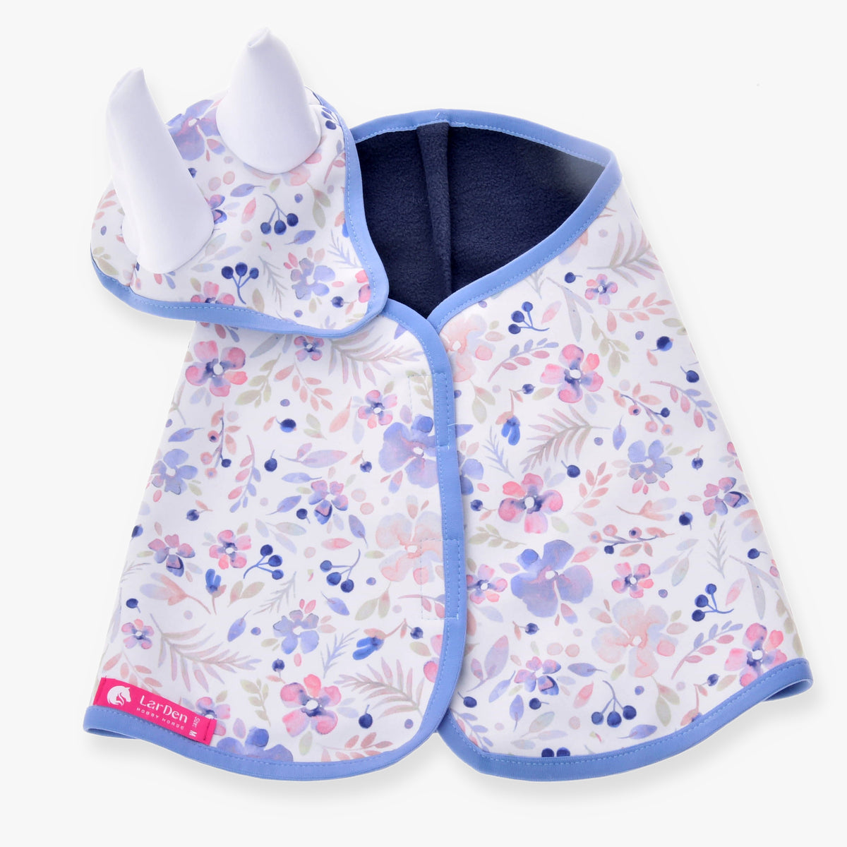 The Set Vanessa NEW by Hobby Horse LarDen features a baby cape and matching hat with white horn-like details and a pastel floral pattern with blue trim—ideal as a whimsical blanket set or playful ear bonnet for little ones.