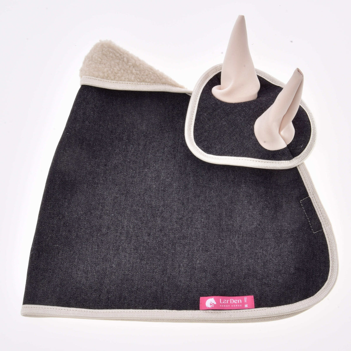 A stylish ear bonnet from Hobby Horse LarDen, Set Blue Denim, features dark gray fabric, cream trim, sherpa-lined top, two light-colored ears, and a pink "LarDen" label on the edge—ideal for hobby horse decoration.