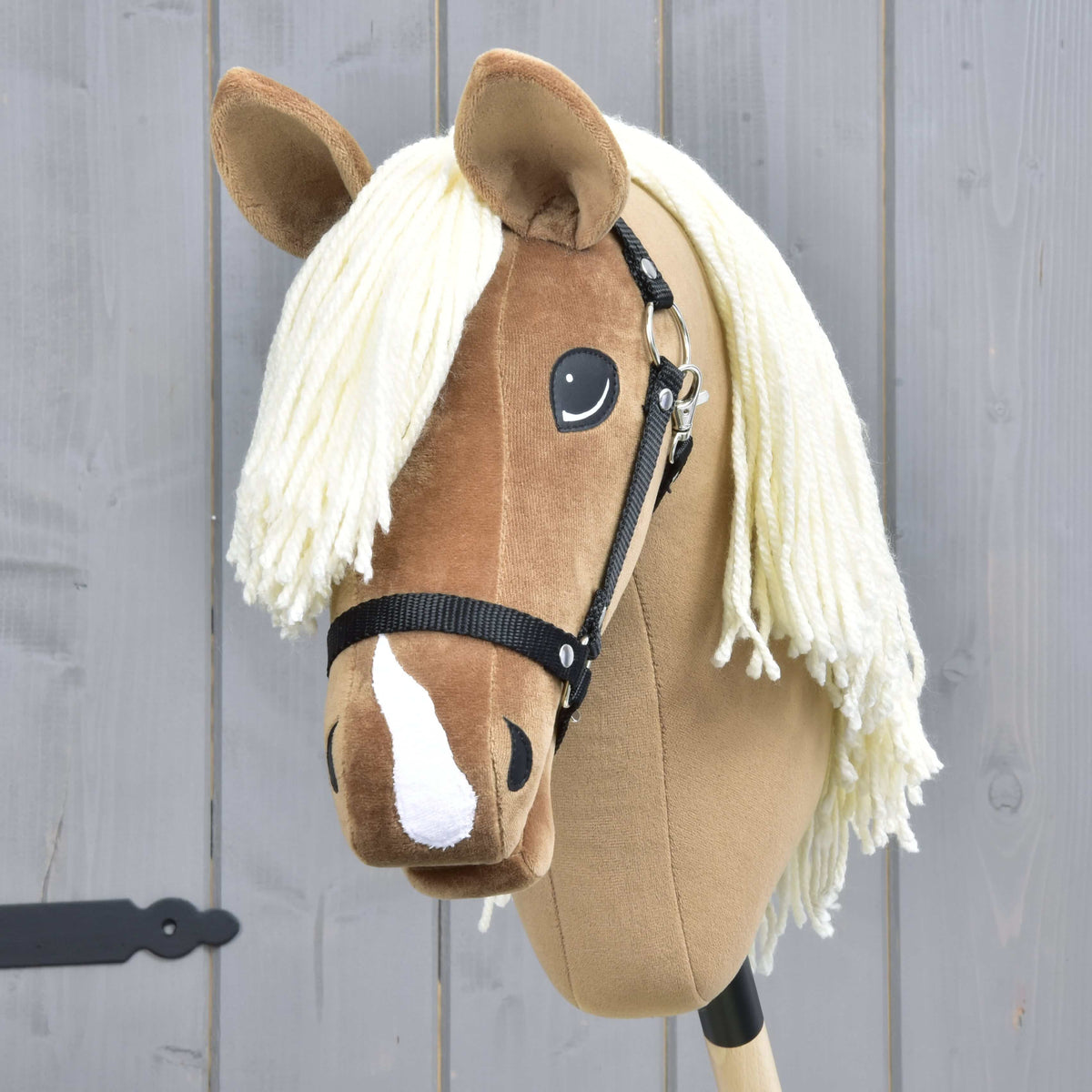The Hobby Horse Smart with Black Halter by Hobby Horse LarDen features a light brown face, white yarn mane, black halter, and white blaze—perfect for western disciplines and imaginative play.