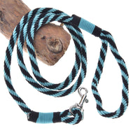 The Hobby Horse LarDen "Hobby Horse - Lead rope stripe green" is coiled on a wooden log. This lead rope features a comfortable handle loop and reinforced ends, making it perfect for hobby horses or pets.