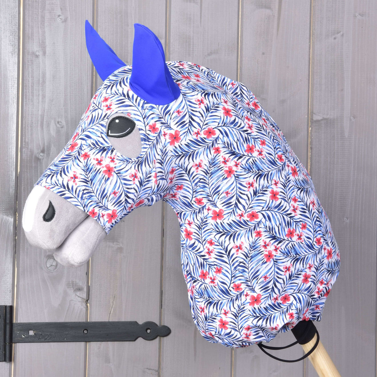 Hobby Horse protective suit Avatar (Lycra) by LarDen on a grey head, white with blue palm leaves, red flowers and blue ears