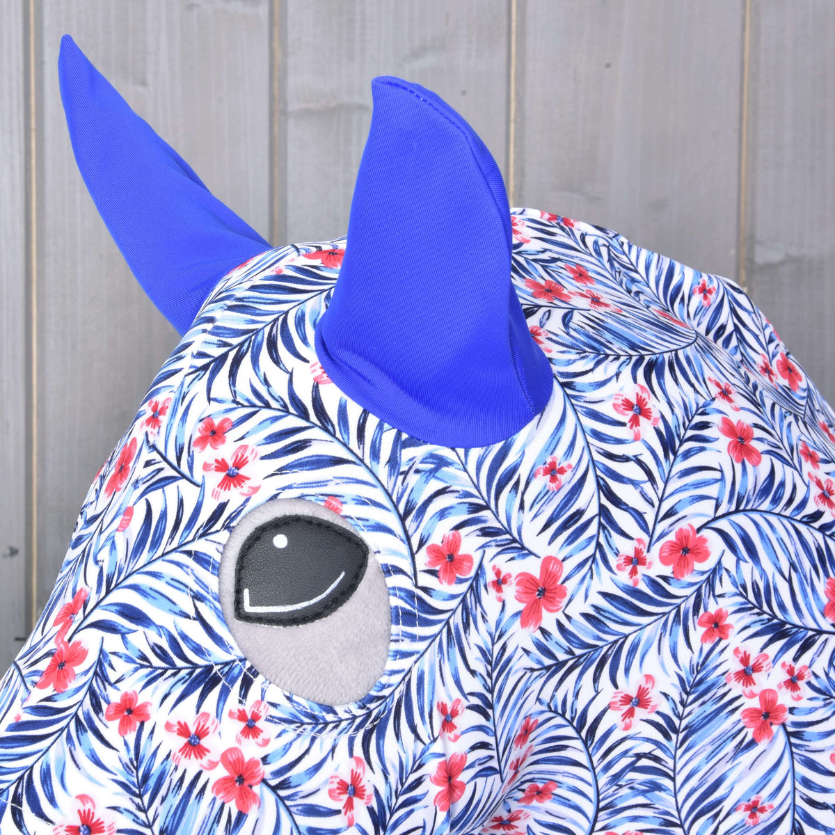 Close-up of the royal blue ears and eye opening on the white Lycra suit with blue palm leaves and red flowers