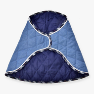 The Blanket Beautiful Jeans by Hobby Horse LarDen is a quilted blue and navy pet coat with white trim and plaid edging, featuring a curved, overlapping design and diamond stitching, shown flat on a white background.