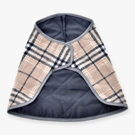 The Blanket Cremo England by Hobby Horse LarDen is a stylish small quilted plaid dog coat in beige, black, and white checks with gray trim and a wrap-around design—ideal for pairing with an ear bonnet for added insect protection. Laid flat on white background.