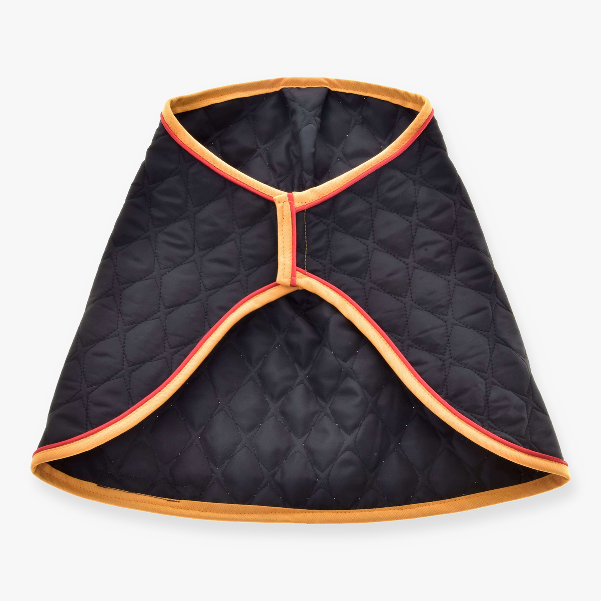 The Blanket Flag by Hobby Horse LarDen is a black quilted cape with tan and red trim, inspired by a warm horse blanket, featuring an open front and diamond stitching.