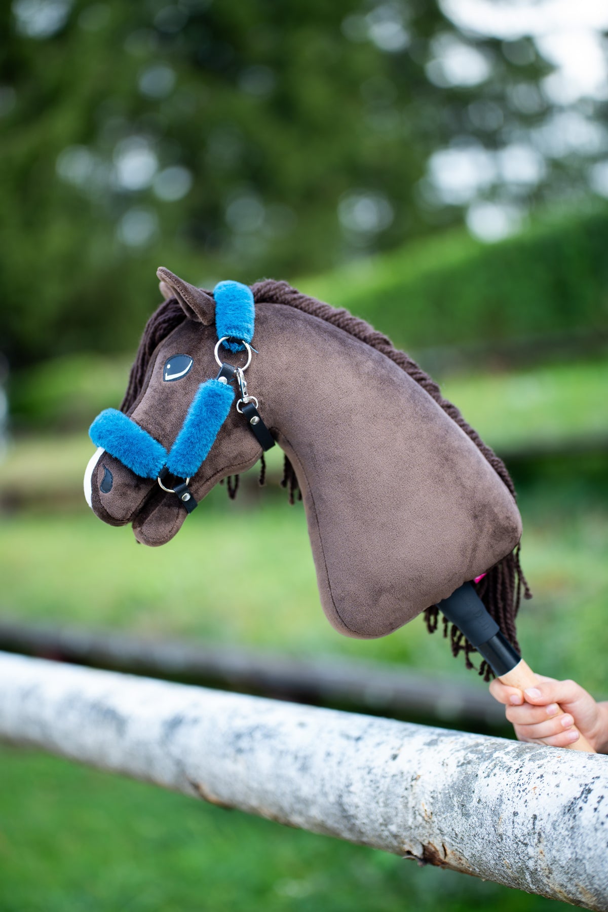 Brown Hobby Horse wearing Fur Halter Teddy Petrol with bright blue fur trim and black leatherette straps