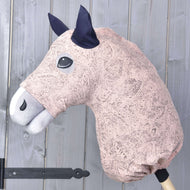 The Hobby Horse LarDen "Cosmos" protective suit (Lycra) in pink and white, with dark ears, is shown mounted on a wooden stick against a light gray wooden wall.