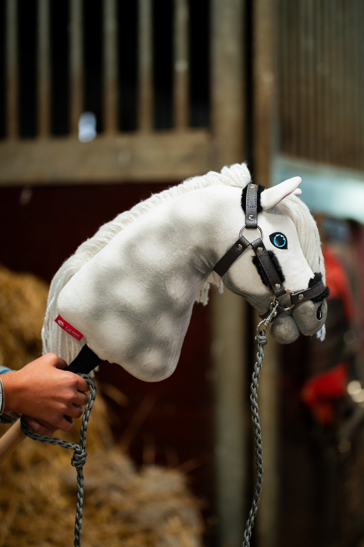 Hobby Horse Halter with fur - leatherette Graphite Full on a grey plush horse with braided lead