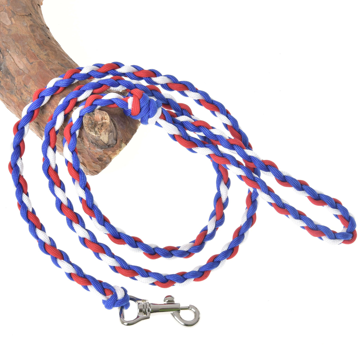The Hobby Horse LarDen "Hobby Horse - rope stripe Flag CZ" leash, in blue, red, and white with a metal clip and looped handle, is coiled on wood—ideal for guiding your pet or as a hobby horse leash.