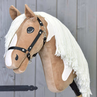 The Hobby Horse LarDen "Hobby Horse Fury with Black Halter" features a plush tan and white face, long white mane, black halter, and sits mounted on a stick, ready for trail rides against a gray wooden background.