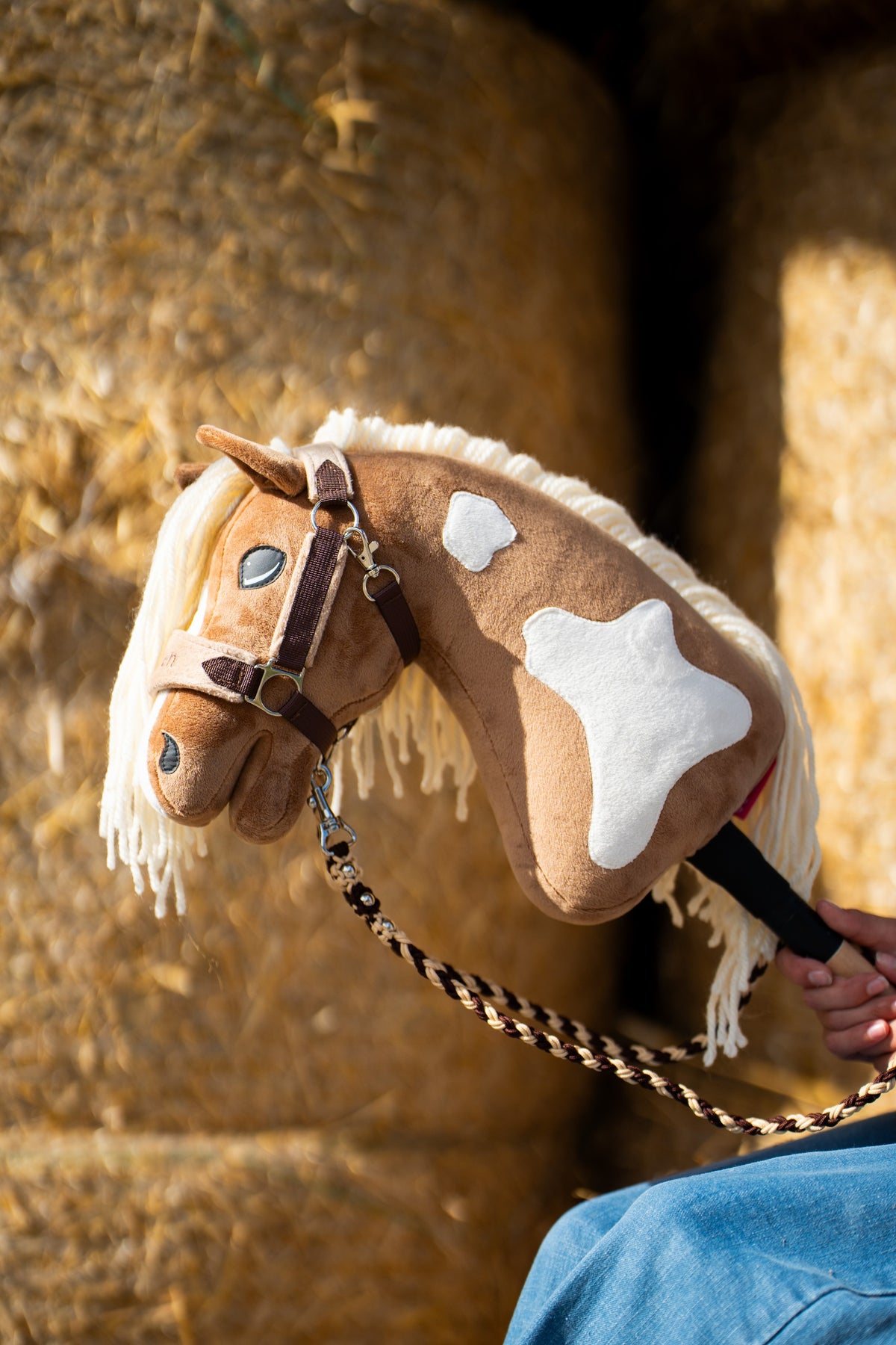 Hobby Horse Lead Rope Bloom Brown attached to a brown Hobby Horse beside straw bales