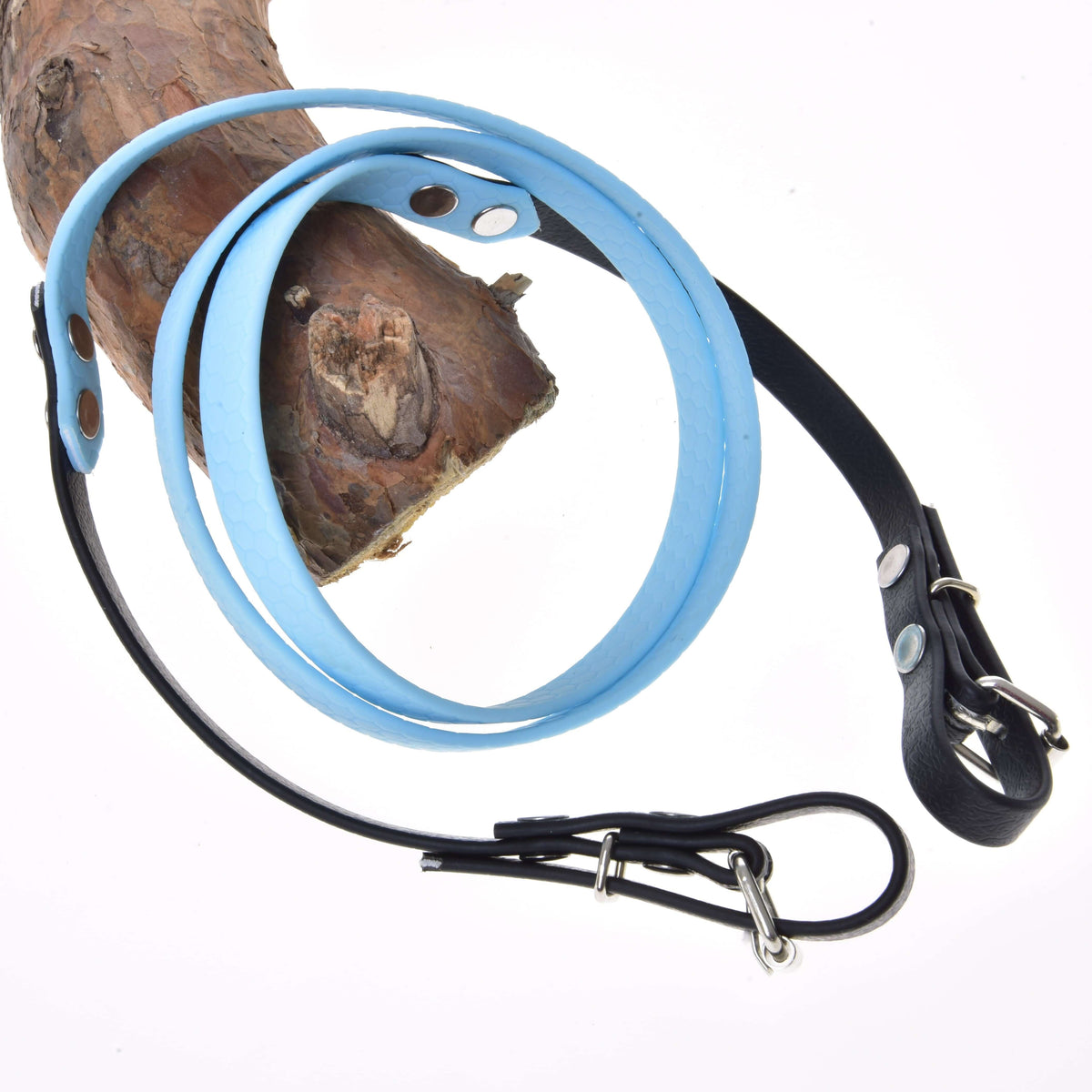 The Reins rubberized Light blue by Hobby Horse LarDen, featuring light blue and black leather with a metal buckle and bridle-inspired design, is wrapped around wood and displayed against a white background.