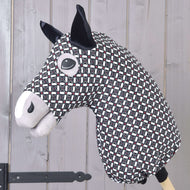 The Hobby Horse LarDen Hobby Horse protective suit DeLuxe (Lycra) features black, white, and red geometric fabric with black ears and stitched facial details, shown on a light wooden paneled background.