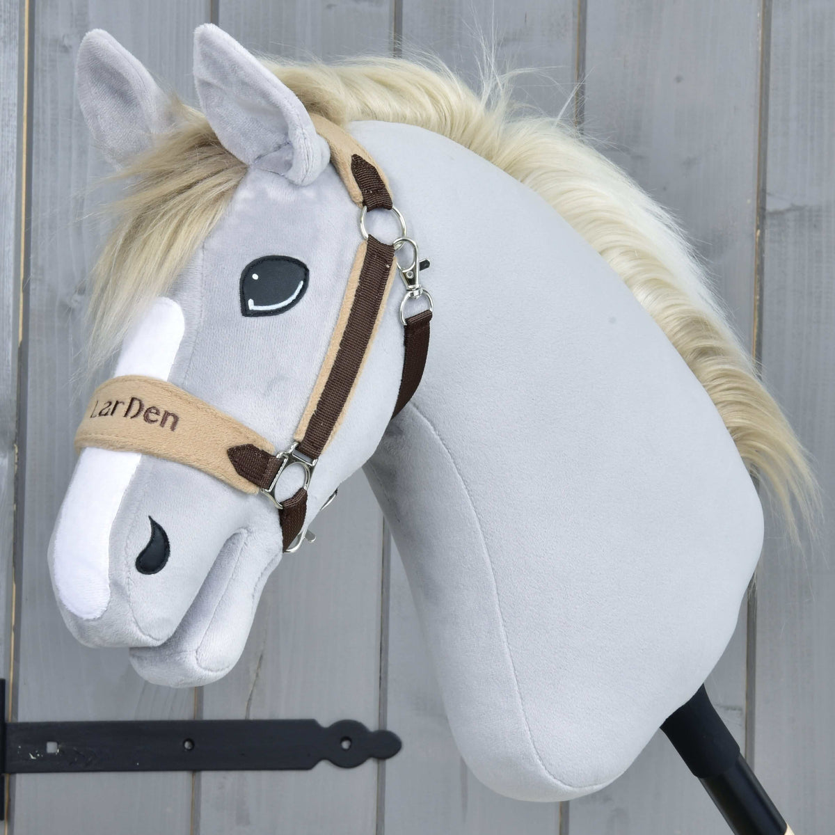Grey plush Hobby Horse with a cream mane wearing the brown fur halter, LarDen embroidered on the beige noseband