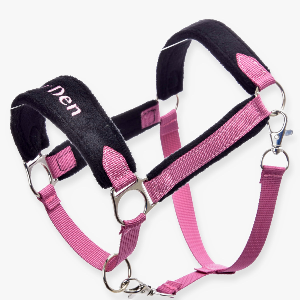 The Fur Halter LarDen Pink by Hobby Horse LarDen features pink and black colors, metal rings, adjustable straps, soft padding for comfort, pink fur accents, and “Den” partially visible on the noseband.