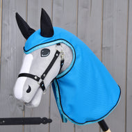 The Hobby Horse LarDen "Raincoat Sky Blue" features a gray and white hobby horse with black reins and ears, wearing a shiny sky blue raincoat-style hood, posed against a wooden background.