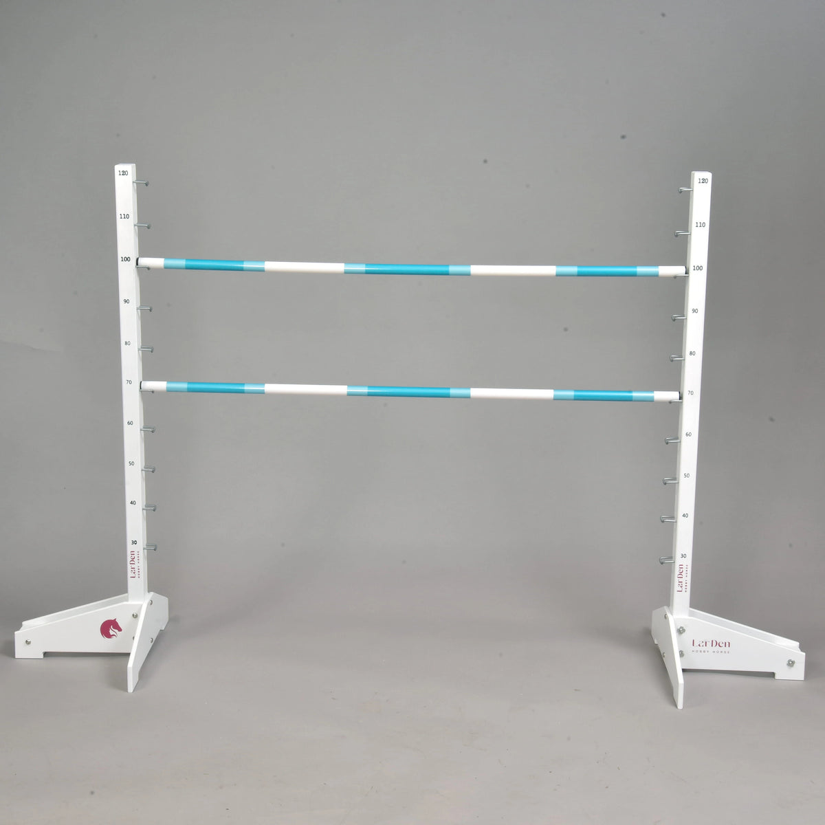 LarDen Hobby Horse Jump with two turquoise and white poles on white wooden stands with a height scale up to 120 cm