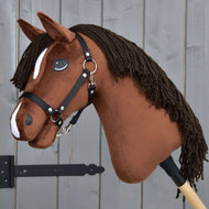 Hobby Horse LarDen's "Rocky with Black Halter" features a handmade brown plush head, black yarn mane, white markings, and a black halter, inspired by a Thoroughbred stallion and mounted on a wooden stick.