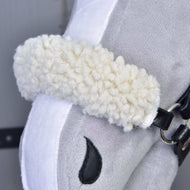 Close-up of the Set Harmony Elsa by Hobby Horse LarDen, showing its white, curly plush noseband, black faux leather bridle, and stitched black nostril on soft gray and white fabric.