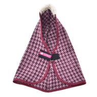 The Stable Blanket Winter Magic by Hobby Horse LarDen features pink and black houndstooth PES fabric, burgundy trim, a fluffy white collar, black strap fastener, and a pink Loff Petit label—ideal for adding chic style to your hobby horse.