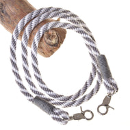 Hobby Horse LarDen's "Hobby Horse - Reins silver stripe" features hand-twisted gray and white polypropylene rope with metal clips on both ends and reinforced ends—ideal for hobby horse reins or creative projects.
