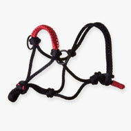 The Hobby Horse LarDen Rope halter Spark is a black rope halter with red accents on one side and metal rings, ideal for handling and training horses or as a unique accessory for your hobby horse.